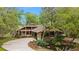 Stunning home exterior with a stone facade and pond feature at 2162 Se Mill Creek Cir, Ocala, FL 34471