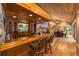Inviting wet bar with wood details and seating for guests at 2162 Se Mill Creek Cir, Ocala, FL 34471