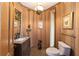 Small bathroom with wood walls and granite vanity at 2162 Se Mill Creek Cir, Ocala, FL 34471