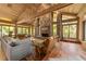 Bright living room with hardwood floors, stone fireplace, and large windows at 2162 Se Mill Creek Cir, Ocala, FL 34471