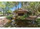Home nestled amongst trees with a pond feature at 2162 Se Mill Creek Cir, Ocala, FL 34471