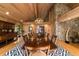 Elegant dining room showcasing a large table, hardwood floors and wood-paneled walls at 2162 Se Mill Creek Cir, Ocala, FL 34471