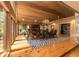 Sunlit dining room with hardwood floors, a large table, and wood-paneled walls at 2162 Se Mill Creek Cir, Ocala, FL 34471