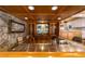 Home bar with wood cabinetry, stone wall, and a tropical-themed stained glass piece at 2162 Se Mill Creek Cir, Ocala, FL 34471