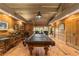 Game room featuring a pool table, hardwood floors, and wood-paneled walls at 2162 Se Mill Creek Cir, Ocala, FL 34471