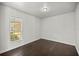 Simple bedroom with dark hardwood floors and a window at 4725 Sw 62Nd St, Ocala, FL 34474