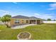 Large backyard with patio, grass lawn, and fire pit at 4725 Sw 62Nd St, Ocala, FL 34474
