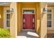 Red front door entrance with sidelights and lanterns at 4725 Sw 62Nd St, Ocala, FL 34474