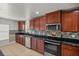 Kitchen with stainless steel appliances and dark wood cabinets at 4725 Sw 62Nd St, Ocala, FL 34474