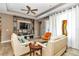 Living room with comfy seating, built-in shelving and a large TV at 5662 Nw 40Th Pl, Ocala, FL 34482
