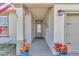 Covered front entryway with gray door and blue potted plants at 5662 Nw 40Th Pl, Ocala, FL 34482
