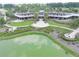 Community clubhouse with pond and landscaping at 5662 Nw 40Th Pl, Ocala, FL 34482