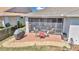 Brick paver patio with screened enclosure and outdoor furniture at 5662 Nw 40Th Pl, Ocala, FL 34482