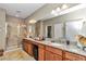 Double vanity bathroom with granite countertops and walk-in shower at 5662 Nw 40Th Pl, Ocala, FL 34482