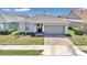 One-story home with gray siding, two-car garage, and landscaped yard at 5662 Nw 40Th Pl, Ocala, FL 34482