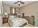 Guest bedroom with a queen-size bed, dresser, and neutral decor at 5662 Nw 40Th Pl, Ocala, FL 34482
