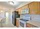 View of kitchen with white appliances and wood cabinets at 2093 Nw 50Th Cir, Ocala, FL 34482