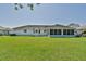 Large backyard with lush green grass and a view of the home at 2093 Nw 50Th Cir, Ocala, FL 34482
