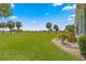 View of the backyard showcasing a golf course and lush landscaping at 2569 Nw 55Th Avenue Rd, Ocala, FL 34482