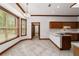 Kitchen with wood cabinets, tile floors, and an island at 7086 Se 12Th Cir, Ocala, FL 34480