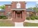 Front entrance of brick house with double doors and walkway at 7086 Se 12Th Cir, Ocala, FL 34480
