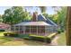 Brick house with a screened pool and lush landscaping at 7086 Se 12Th Cir, Ocala, FL 34480
