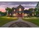 Brick house exterior at dusk with walkway and landscaping at 7086 Se 12Th Cir, Ocala, FL 34480