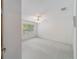 Well-lit bedroom featuring carpet, window, and ceiling fan at 7086 Se 12Th Cir, Ocala, FL 34480