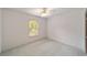 Simple bedroom with a window and ceiling fan at 7086 Se 12Th Cir, Ocala, FL 34480