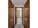 Bathroom hallway with wood doors leading to the bathroom at 7086 Se 12Th Cir, Ocala, FL 34480