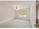 Spacious bedroom with carpeted floor and large window at 7086 Se 12Th Cir, Ocala, FL 34480