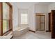 Bathroom with corner bathtub and a separate shower at 7086 Se 12Th Cir, Ocala, FL 34480