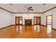Spacious living room featuring hardwood floors, a fireplace, and access to a pool at 7086 Se 12Th Cir, Ocala, FL 34480