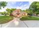 Brick house with a manicured lawn and circular driveway at 7086 Se 12Th Cir, Ocala, FL 34480