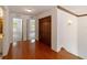 Bright hallway with wood floors and access to bedrooms at 7086 Se 12Th Cir, Ocala, FL 34480
