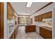 Kitchen with wood cabinets, tile floor, and island at 7086 Se 12Th Cir, Ocala, FL 34480