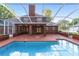 Large screened pool with brick patio and house view at 7086 Se 12Th Cir, Ocala, FL 34480