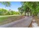 Concrete pathway alongside a lush golf course at 7086 Se 12Th Cir, Ocala, FL 34480