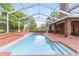 Inviting screened pool with brick patio and steps at 7086 Se 12Th Cir, Ocala, FL 34480