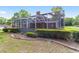 Brick house with screened pool and lush landscaping at 7086 Se 12Th Cir, Ocala, FL 34480