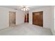 Spacious bedroom with carpet, ceiling fan, and private bathroom access at 7086 Se 12Th Cir, Ocala, FL 34480