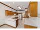 Kitchen with wood cabinets, tile floors, and an island at 7086 Se 12Th Cir, Ocala, FL 34480