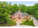 Brick house with large yard and driveway, surrounded by trees at 7086 Se 12Th Cir, Ocala, FL 34480