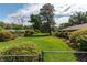 Large backyard with lush green grass and mature trees at 735 Se 22Nd Ave, Ocala, FL 34471