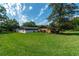 Spacious backyard with lush grass and trees at 735 Se 22Nd Ave, Ocala, FL 34471
