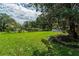Expansive backyard featuring a grassy lawn and landscape at 735 Se 22Nd Ave, Ocala, FL 34471