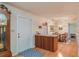 Inviting entryway with wood flooring, a built-in bar, and a grand grandfather clock at 735 Se 22Nd Ave, Ocala, FL 34471