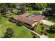 Aerial view of single-story home, pool, and expansive lawn at 735 Se 22Nd Ave, Ocala, FL 34471