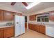 Modern kitchen with wood cabinets, white appliances, and ample counter space at 735 Se 22Nd Ave, Ocala, FL 34471