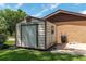 White metal storage shed with a single door and window at 735 Se 22Nd Ave, Ocala, FL 34471